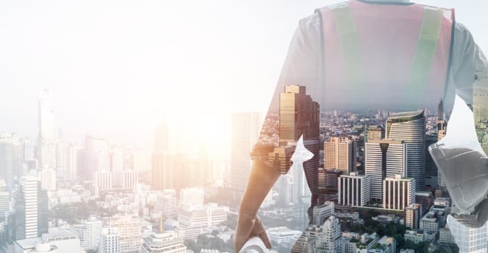 Field service engineer silhouette against a city scape