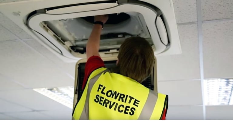 Flowrite engineer fixing a ceiling air condition unit